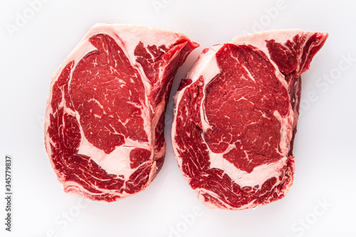 Photos Two freshly cut boneless ribeye steaks on a butchers table
