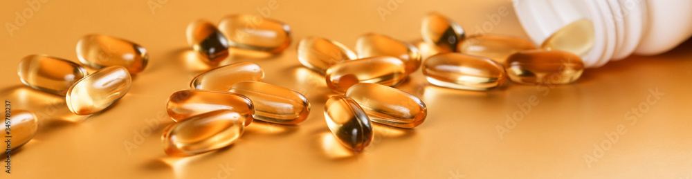 Many capsules Omega 3 on yellow background. Close up, high resolution product. Health care concept. Many capsules Omega 3 on yellow background. Close up, high resolution product. Health care concept.