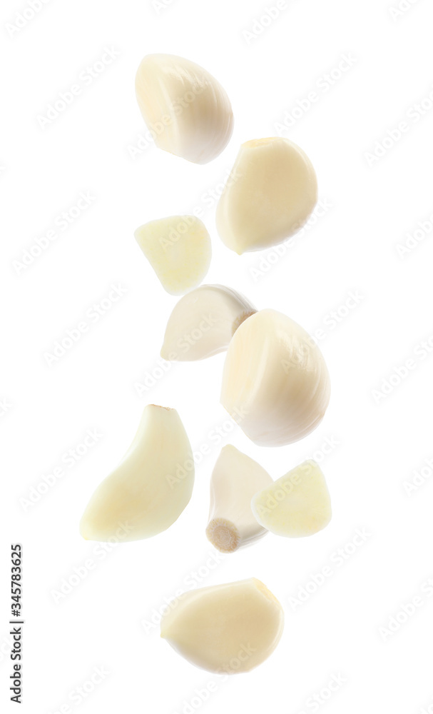 Set of falling garlic cloves on white background Set of falling garlic cloves on white background