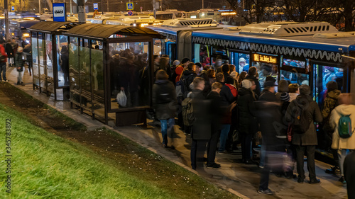 Passengers waiting and boarding buses at the bus terminal