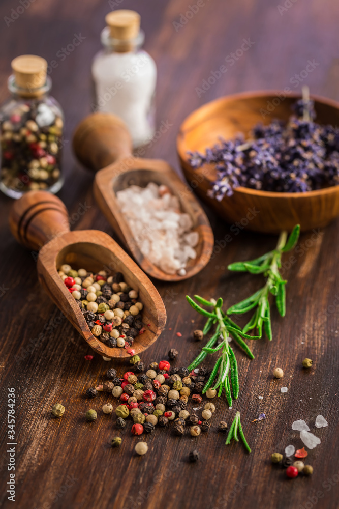 Salt, pepper with rosamary and lavender on wooden background Salt, pepper with rosamary and lavender on wooden background
