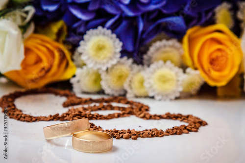 Wedding rings against the background of the bride's bouquet.