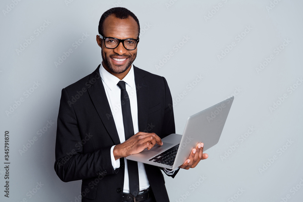 Portrait of his he nice attractive imposing cheerful bearded guy ceo boss chief banker holding in hands digital laptop using e-banking service isolated on grey pastel color background Portrait of his he nice attractive imposing cheerful bearded guy ceo boss chief banker holding in hands digital laptop using e-banking service isolated on grey pastel color background