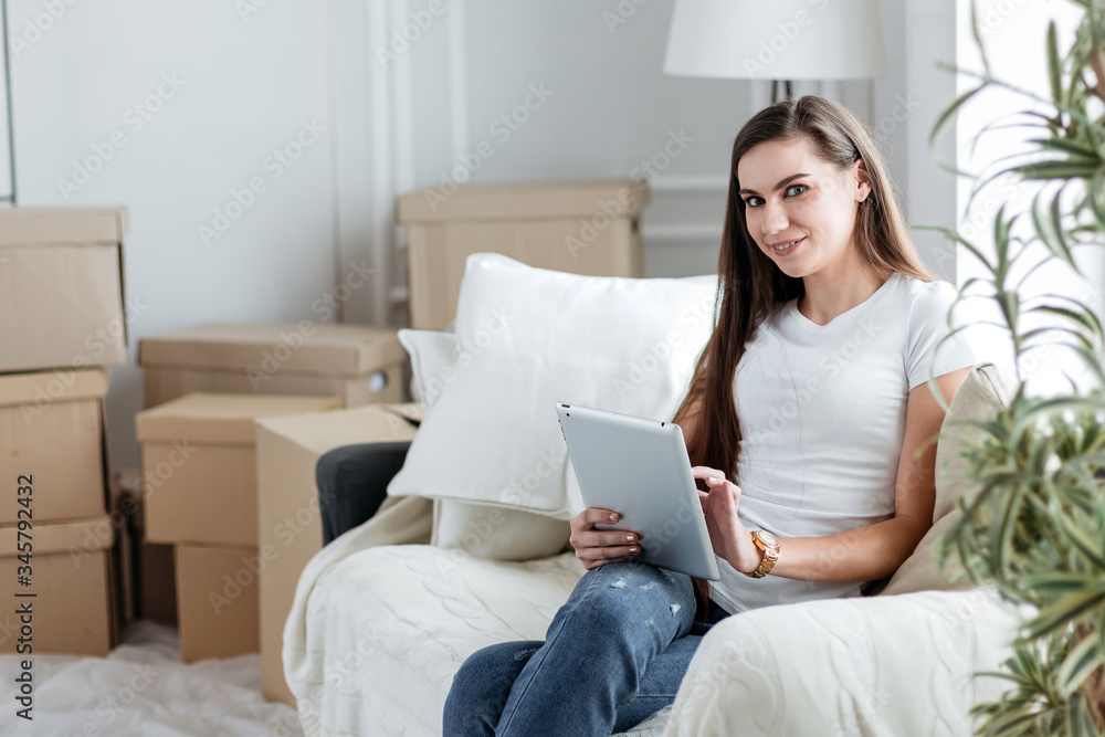 young woman uses a digital tablet to pay for a loan young woman uses a digital tablet to pay for a loan