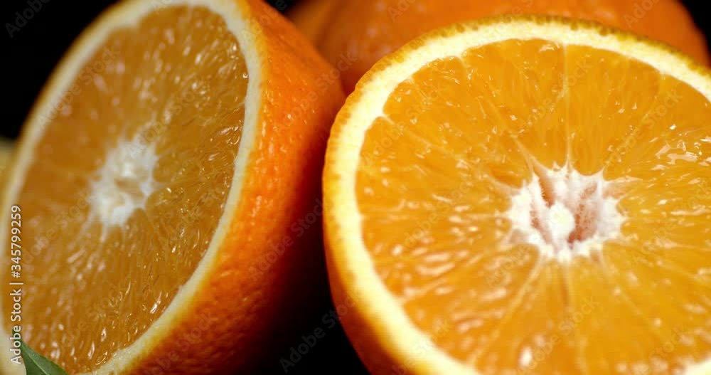 Half of juicy oranges slowly rotate. Half of juicy oranges slowly rotate.