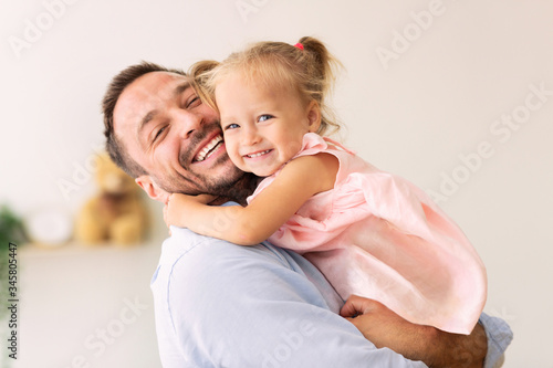 Caucasian father holding his cute loving daughter