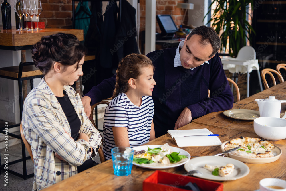 Young parents helping their daughter to compose a letter Young parents helping their daughter to compose a letter