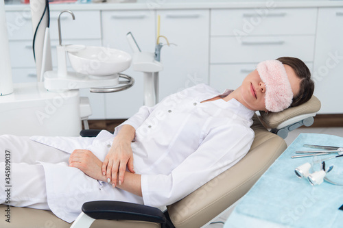 Young doctor asleep on a dentistry seat