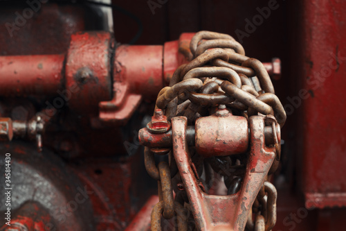 Old farm tractor hydraulic lift arm and chain detail