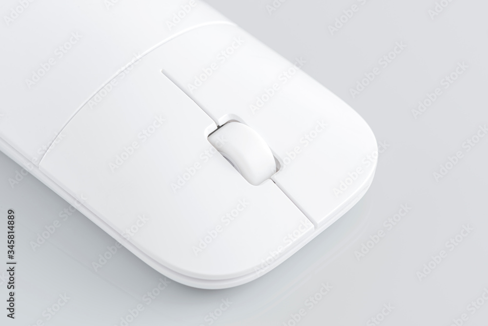 Wireless computer mouse on the gray background. Wireless computer mouse on the gray background.