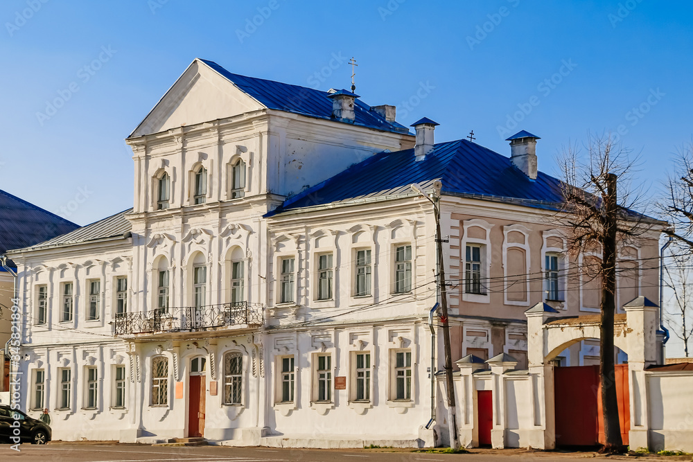 Naklejka premium Beautiful old house. Ancient building of the 19th century against a blue sky.