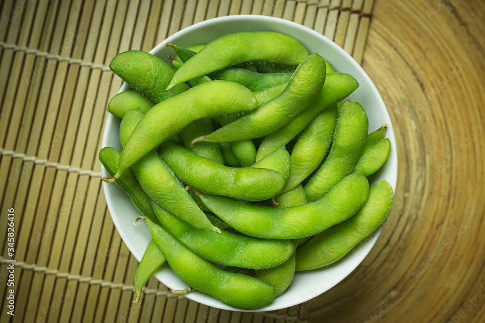 Edamame  in white bowl top view image for food content.