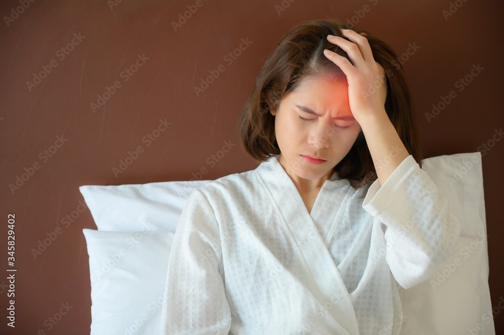 Cropped shot of woman having headache on one side of head it cause from migraine. A migraine can cause severe throbbing pain or a pulsing sensation. Cropped shot of woman having headache on one side of head it cause from migraine. A migraine can cause severe throbbing pain or a pulsing sensation.