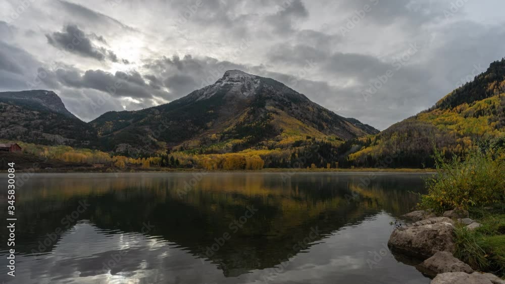 Timelapse Of Stormy Clouds Above Crystal Lake and Mountain Hills in Autumn Colors Timelapse Of Stormy Clouds Above Crystal Lake and Mountain Hills in Autumn Colors