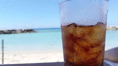 Ice cold drink in front of a beautiful beach photo