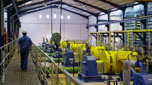DS WS Worker walking on gangway through compressor hall in water treatment plant