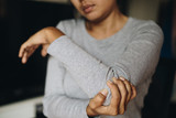 Young asian woman feel pain in her elbow, Health problems concept