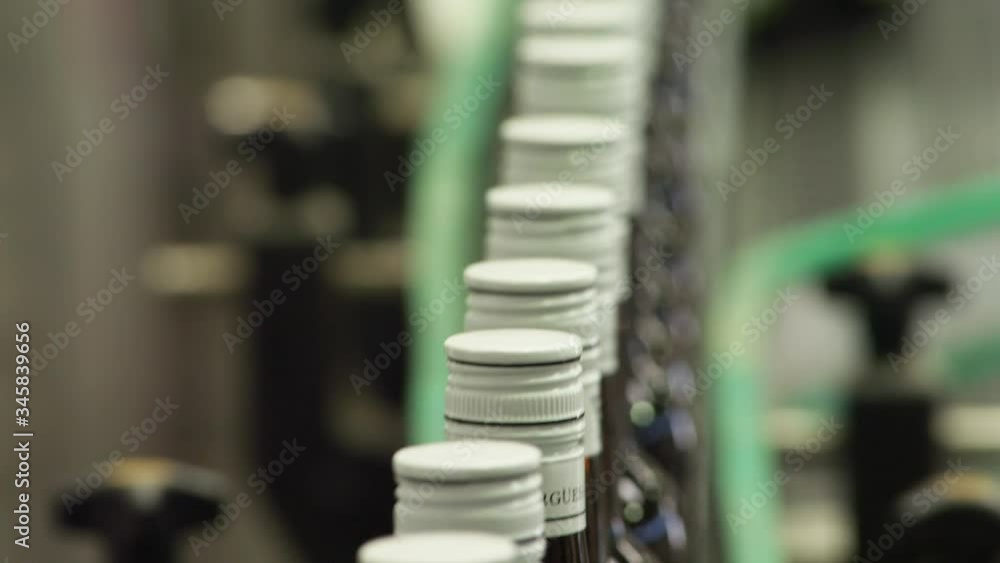 CU Bottles with caps moving along conveyor belt CU Bottles with caps moving along conveyor belt