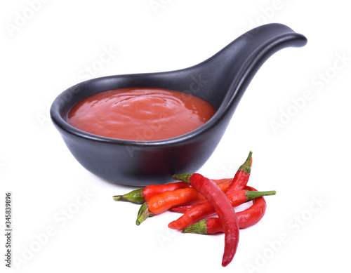 Red chilli and chilli sauce on a white background