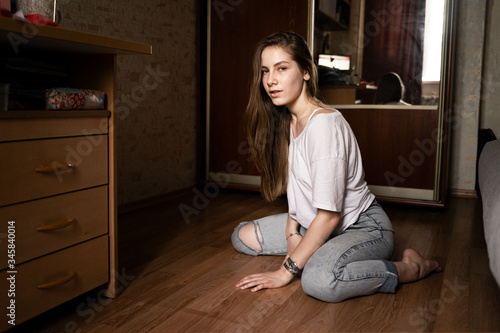 girl sitting in the middle of the room looking at the camera