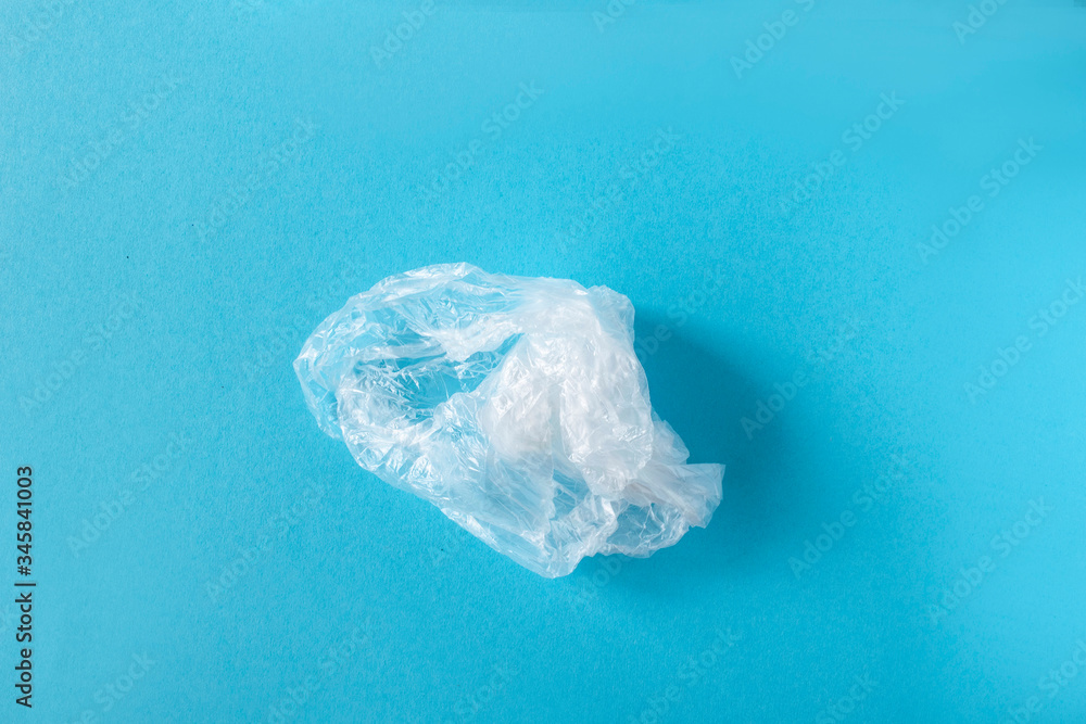 White plastic on a blue background. Plastic pollution. Recycling plastic, reusable packing, sorting garbage concept. Zero waste, ecology. Copyspase,