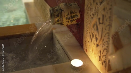 CU Water pouring into bathtub in traditional Arab bathhouse (hammam)