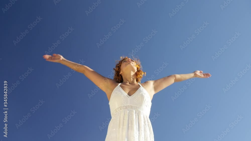 MS Young woman practising yoga against clear blue sky MS Young woman practising yoga against clear blue sky