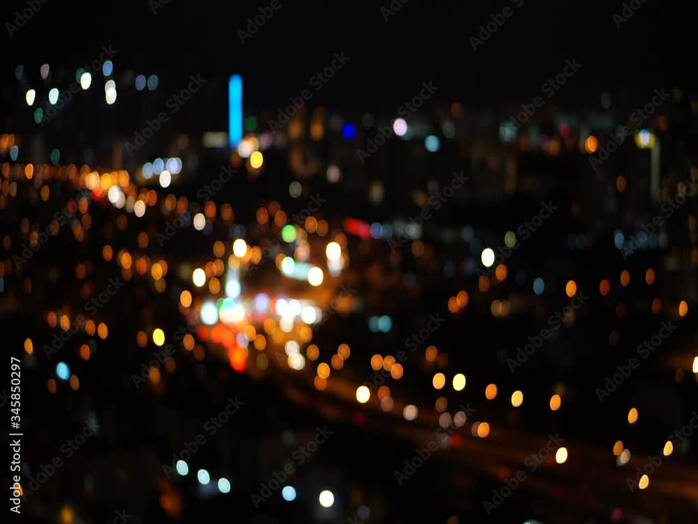 Vehicle lights moving with colorful city lights and flashing at night look blurry and bokeh. Vehicle lights moving with colorful city lights and flashing at night look blurry and bokeh.