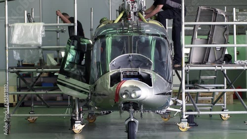 WS TU Two aircraft mechanics working on helicopter
