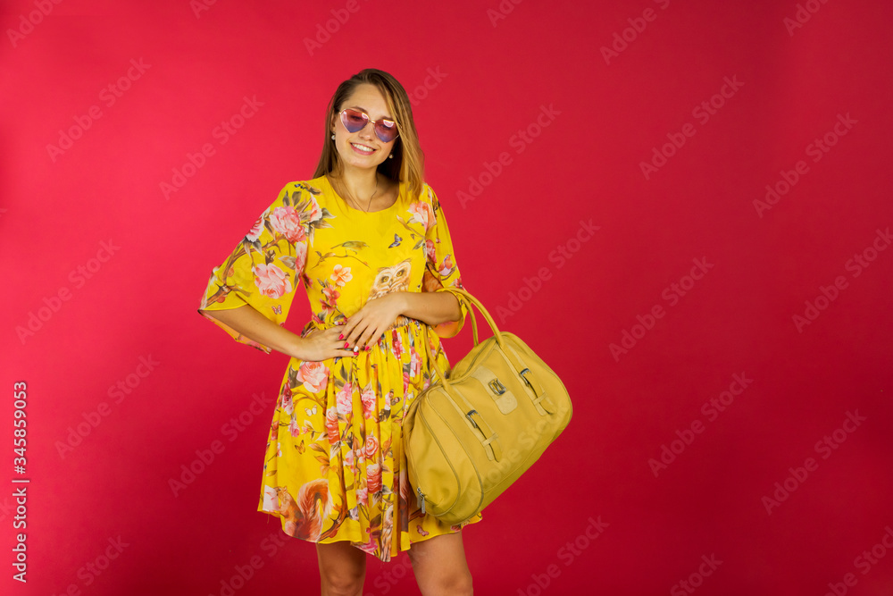 Pretty blonde woman with bag posing in studio Pretty blonde woman with bag posing in studio
