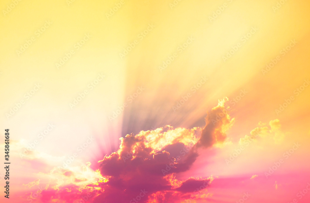 Fototapeta premium bright sun Behind neon light pink clouds with orange light and sun rays