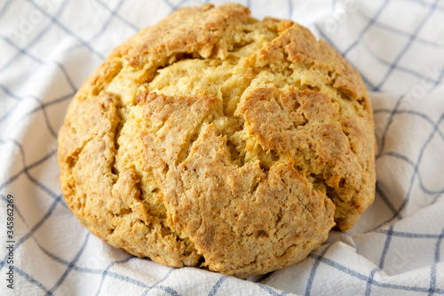 Homemade Irish Soda Bread on cloth, side view. Close-up. photo