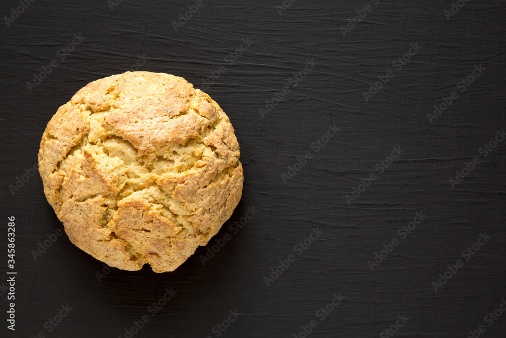 Homemade Irish Soda Bread on a black background, top view. Flat lay, overhead, from above. Copy space. Homemade Irish Soda Bread on a black background, top view. Flat lay, overhead, from above. Copy space.