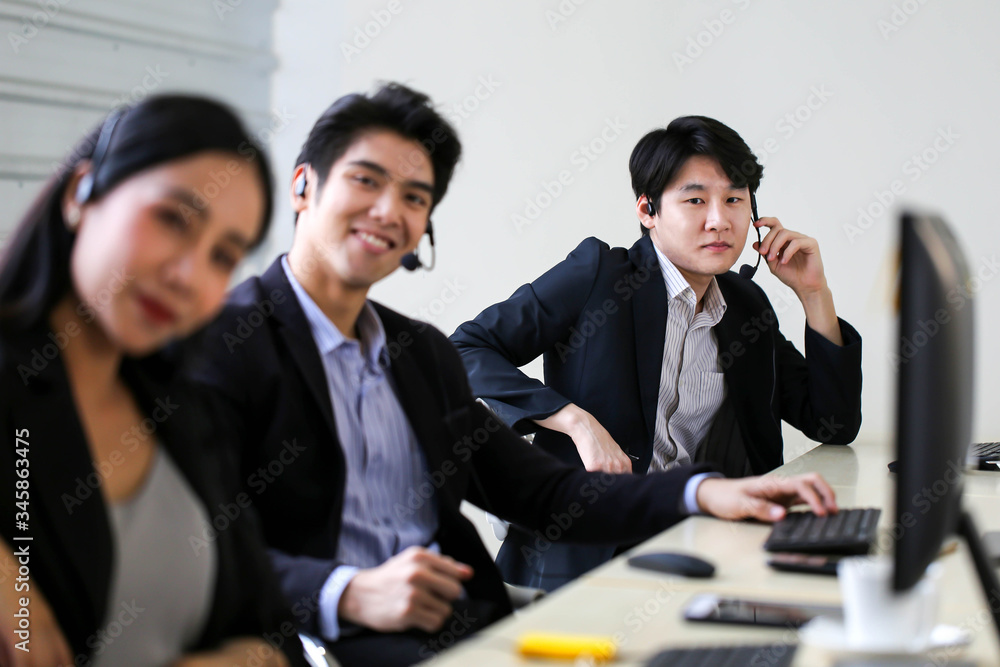 Asia Group of call center workers or Confident business team with headset in office. Asia Group of call center workers or Confident business team with headset in office.