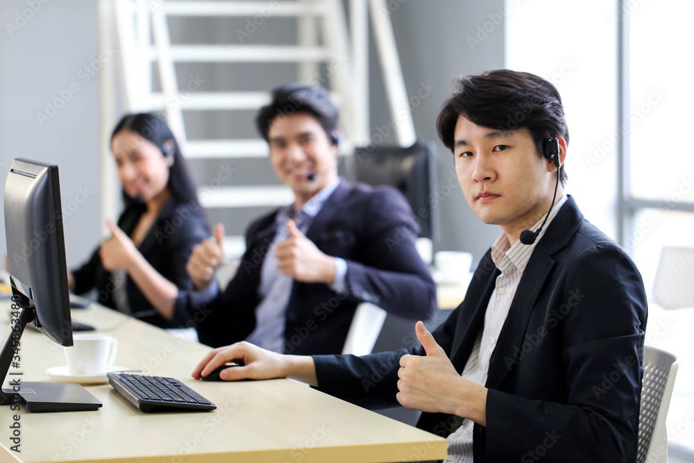 Asia Group of call center workers or Confident business team with headset in office. Asia Group of call center workers or Confident business team with headset in office.