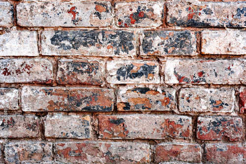 Texture of a brick wall with cracks and scratches which can be used as a background © chernikovatv