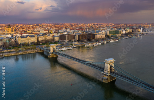 Budapest, Hungary - Aerial view of the Szechenyi Chain Bridge at sunset with colorful sky and St.Stephen's Basilica. The bridge and the streets are totally empty due to 2020 Coronavirus quarantine