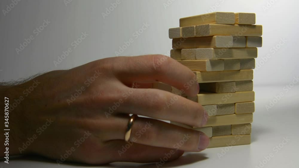 Close up hand holding blocks wood game jenga isolated on white background. Close up hand holding blocks wood game jenga isolated on white background.