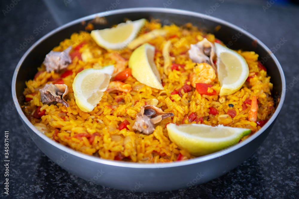 Seafood paella, traditional spanish food. Pan full of rice cooked with vegetables, shellfishs and shrimps Seafood paella, traditional spanish food. Pan full of rice cooked with vegetables, shellfishs and shrimps