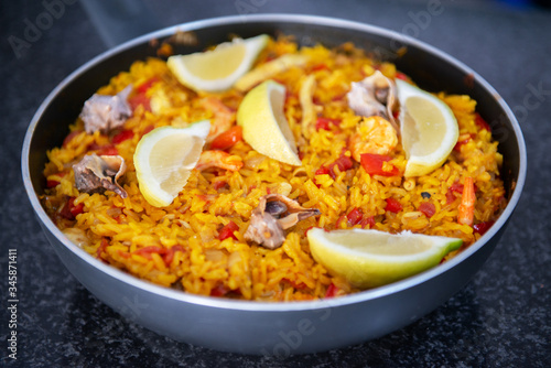 Seafood paella, traditional spanish food. Pan full of rice cooked with vegetables, shellfishs and shrimps