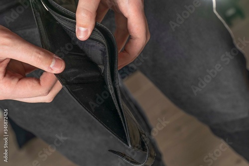 Bankruptcy - Businessman holding an empty wallet