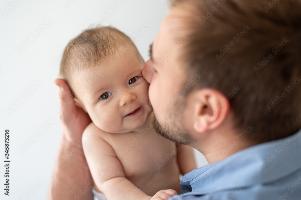 Young father holding his newborn baby daughter Young father holding his newborn baby daughter