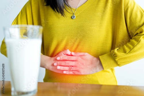 Canvas Print Woman having a stomach pain and a glass of milk,Allergy dairy intolerant,Lactose