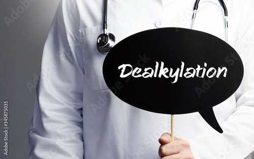 Dealkylation. Doctor in smock holds up speech bubble. The term Dealkylation is in the sign. Symbol of illness, health, medicine photo