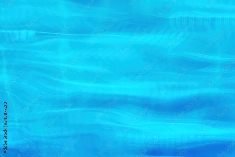 Blue water waves in the swimming pool. Background texture pattern
