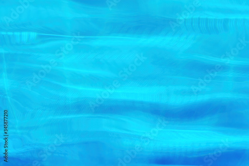 Blue water waves in the swimming pool. Background texture pattern