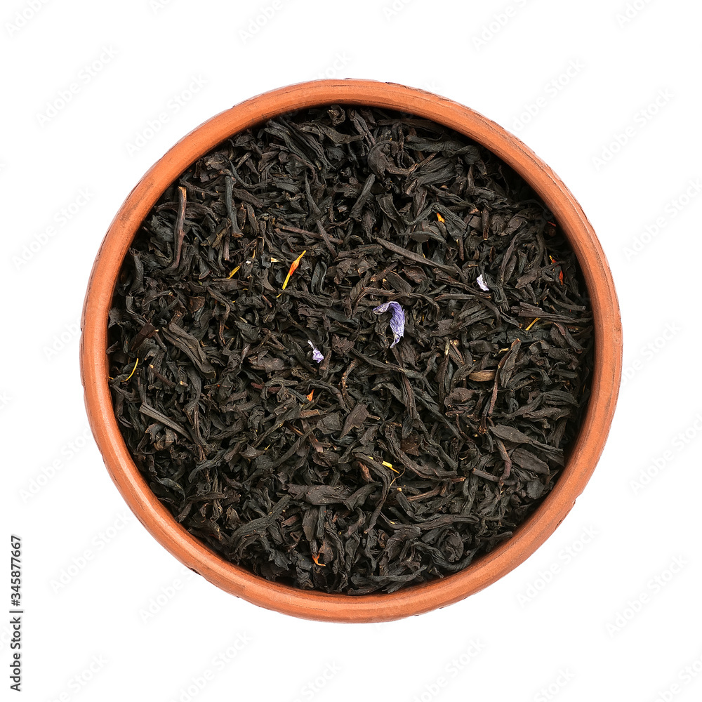 Fototapeta premium Dry black tea with flower petals in the bowl Isolated on a white background. View from above