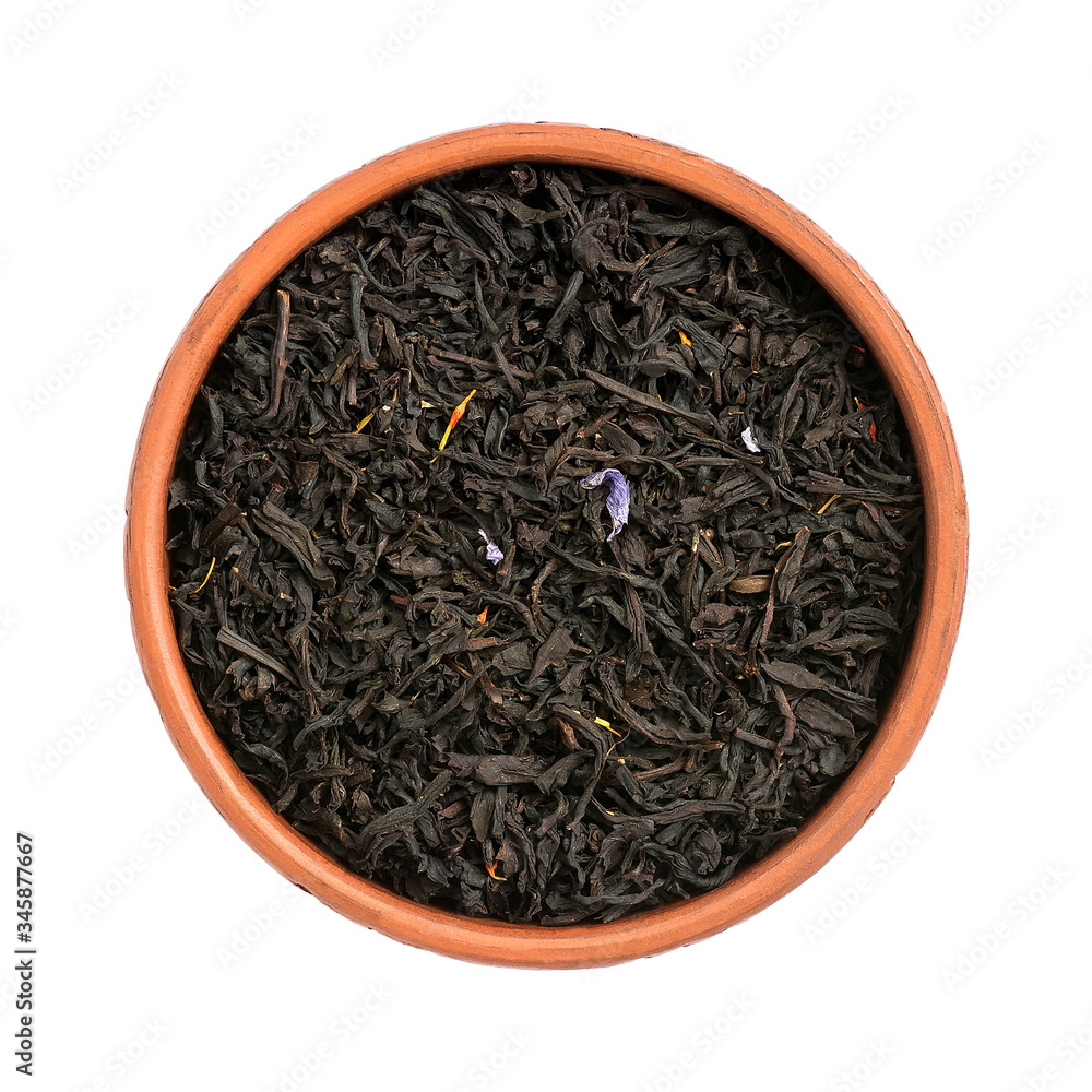 Dry black tea with flower petals in the bowl Isolated on a white background. View from above