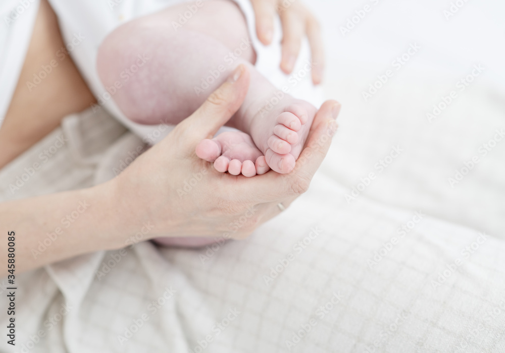 Selective focus leg the sleeping baby in the hand of mother close-up Selective focus leg the sleeping baby in the hand of mother close-up