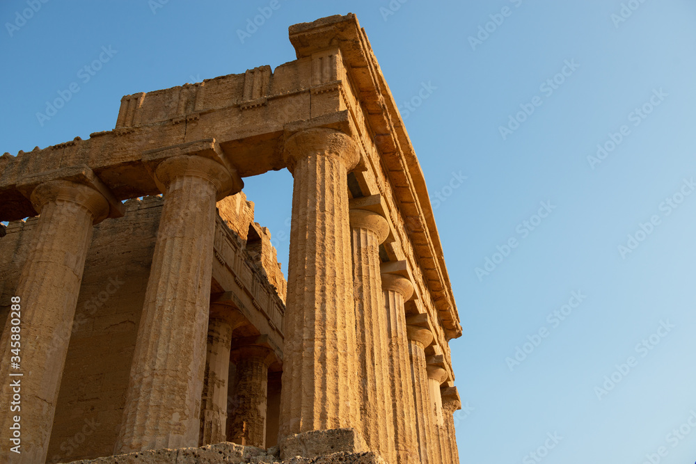 Fototapeta premium Valley of the Temples (Valle dei Templi), an ancient Greek Temple built in the 5th century BC, Agrigento, Sicily. Famous tourist attraction in Italy. Old marble columns of the Doric order.
